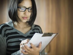 220444 675x450 woman writing on clipboard