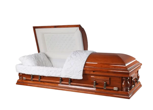 Open casket made of glossy light cherry wood with a white quilted interior and tufted head panel, featuring bronze-tone handles and carved corner details. This warm-toned casket offers a polished, traditional appearance for honoring loved ones.