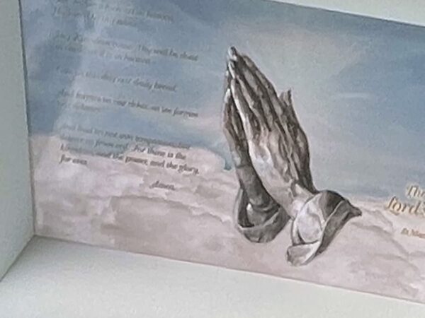A card displaying an illustration of praying hands against a soft blue sky and clouds, accompanied by text in elegant font, conveying a serene and spiritual tone.